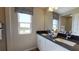 Bright bathroom features double sinks, large mirror, vanity, and a window with natural light at 812 Lake Dell Rd, Dundee, FL 33838