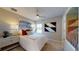 Bright bedroom features a large window, ceiling fan, modern nightstand lamps, and stylish decor at 812 Lake Dell Rd, Dundee, FL 33838