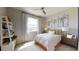 Bright bedroom features a large window, ceiling fan, bookshelf and decorative artwork above the bed at 812 Lake Dell Rd, Dundee, FL 33838