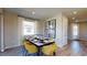The dining room features modern table decor, window, stylish flooring, modern light fixtures and accent wall decor at 812 Lake Dell Rd, Dundee, FL 33838
