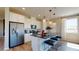 The modern kitchen features stainless steel appliances, white cabinets, an island, modern light fixtures and countertops at 812 Lake Dell Rd, Dundee, FL 33838