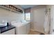 Well-equipped laundry room with washer, dryer, and ample shelving at 812 Lake Dell Rd, Dundee, FL 33838