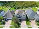 Bird's-eye view of the property, highlighting the home's backyard, three-car garage, and brick-paved driveway at 8228 Randal Park Blvd, Orlando, FL 32832