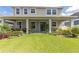 Spacious backyard with covered patio and lush green lawn, ideal for outdoor gatherings and entertainment at 8228 Randal Park Blvd, Orlando, FL 32832