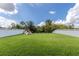 Large backyard with lush green lawn, play structure, and fenced perimeter, perfect for outdoor activities at 8228 Randal Park Blvd, Orlando, FL 32832