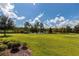 Expansive green backyard overlooking a tranquil lake, creating a serene and picturesque setting at 8228 Randal Park Blvd, Orlando, FL 32832