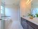 Bathroom featuring double vanity with quartz countertops and shower with tub at 8228 Randal Park Blvd, Orlando, FL 32832
