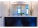 Bathroom with double sink, dark cabinets, and white countertop at 8228 Randal Park Blvd, Orlando, FL 32832