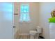 Bathroom with white tile walls and small window at 8228 Randal Park Blvd, Orlando, FL 32832