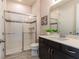 Modern bathroom with walk-in shower with glass doors and vanity with countertop at 8228 Randal Park Blvd, Orlando, FL 32832