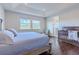 Bedroom featuring tray ceilings, hardwood floors, large windows and a crib at 8228 Randal Park Blvd, Orlando, FL 32832