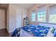 Bedroom featuring hardwood floors, large windows and a -themed bed at 8228 Randal Park Blvd, Orlando, FL 32832