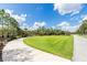 Expansive green lawn within a community, complemented by walking paths and mature trees under a bright sky at 8228 Randal Park Blvd, Orlando, FL 32832