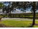 Lakeside view showcasing a calm lake surrounded by trees and a grassy area, offering a serene community space at 8228 Randal Park Blvd, Orlando, FL 32832