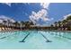 Inviting community pool with clear water, lounge chairs, and palm trees offering a relaxing oasis at 8228 Randal Park Blvd, Orlando, FL 32832