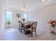 Dining area with table set for dinner, natural light and modern chandelier at 8228 Randal Park Blvd, Orlando, FL 32832