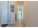 Bright hallway featuring wood-look tile flooring and tasteful decor leading to the home's living spaces at 8228 Randal Park Blvd, Orlando, FL 32832
