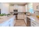 Bright kitchen featuring stainless steel appliances, white cabinets, and marble countertops at 8228 Randal Park Blvd, Orlando, FL 32832