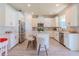 Kitchen with white cabinets, marble countertops, stainless appliances, and an island with seating at 8228 Randal Park Blvd, Orlando, FL 32832