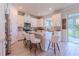 Bright kitchen with white cabinets, marble countertops, stainless appliances, and island seating at 8228 Randal Park Blvd, Orlando, FL 32832