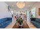 Open-concept living room showcasing kitchen, staircase and elegant decor at 8228 Randal Park Blvd, Orlando, FL 32832