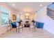Bright and airy living room featuring a fireplace and modern chandelier at 8228 Randal Park Blvd, Orlando, FL 32832