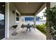 Covered patio with wrought iron table and chairs, offering a relaxing spot for outdoor enjoyment at 8228 Randal Park Blvd, Orlando, FL 32832