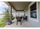 Covered patio with wicker seating and plush cushions, creating an inviting outdoor living space at 8228 Randal Park Blvd, Orlando, FL 32832