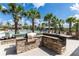 Community pool area with palm trees and a built-in outdoor grill, perfect for summer gatherings at 8228 Randal Park Blvd, Orlando, FL 32832