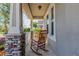 Inviting front porch with stone accents, white railings, and classic rocking chairs for relaxing outdoors at 8228 Randal Park Blvd, Orlando, FL 32832
