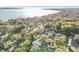 Beautiful aerial view of the property with lush green surroundings and sparkling lake waters at 905 W 11Th Ave, Mount Dora, FL 32757