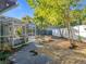 The backyard of this house features a screened-in pool area with a walkway surrounded by lush landscaping at 905 W 11Th Ave, Mount Dora, FL 32757
