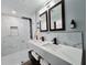 Modern bathroom with double vanity, dual mirrors and walk-in shower with rainfall showerhead at 905 W 11Th Ave, Mount Dora, FL 32757