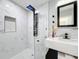 Modern bathroom featuring a frameless glass shower and stylish marble tile and vanity at 905 W 11Th Ave, Mount Dora, FL 32757
