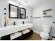 Modern bathroom featuring double vanity, dual mirrors, toilet, shelving and modern fixtures at 905 W 11Th Ave, Mount Dora, FL 32757
