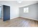Bedroom with vinyl plank flooring, a window, and a closet behind a black sliding door at 905 W 11Th Ave, Mount Dora, FL 32757