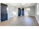 Bright bedroom features a modern light fixture, new flooring, and updated doors at 905 W 11Th Ave, Mount Dora, FL 32757