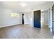 Bright bedroom features a modern light fixture, new flooring, and updated doors at 905 W 11Th Ave, Mount Dora, FL 32757