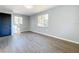Bright bedroom with two windows, painted walls, and vinyl plank flooring at 905 W 11Th Ave, Mount Dora, FL 32757