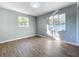 Bedroom with wood floors, two windows for natural light, and neutral paint at 905 W 11Th Ave, Mount Dora, FL 32757