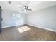 Bedroom with vinyl plank flooring and a window with a ceiling fan and light at 905 W 11Th Ave, Mount Dora, FL 32757