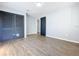 Bedroom with wood floors and ample closet space near the hallway and second bedroom at 905 W 11Th Ave, Mount Dora, FL 32757