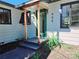 Charming front entrance featuring a glass door with wood accents and modern black shutters at 905 W 11Th Ave, Mount Dora, FL 32757