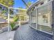 Charming exterior view featuring a unique sunroom design and inviting brick pathway leading to the backyard at 905 W 11Th Ave, Mount Dora, FL 32757