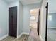 Hallway with storage and an entrance to a tiled bathroom with modern fixtures at 905 W 11Th Ave, Mount Dora, FL 32757