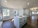 Kitchen boasts a modern island with quartz countertops and stainless steel appliances at 905 W 11Th Ave, Mount Dora, FL 32757