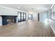 Spacious living room with fireplace, new flooring, and abundant natural light at 905 W 11Th Ave, Mount Dora, FL 32757