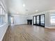 Spacious living room with wood floors, fireplace, and lots of natural light coming through new windows at 905 W 11Th Ave, Mount Dora, FL 32757