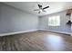 Spacious main bedroom with light walls, wood floors, ceiling fan, and natural light at 905 W 11Th Ave, Mount Dora, FL 32757