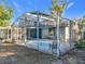 Backyard view of the screened pool area featuring outdoor seating, landscaping, and privacy at 905 W 11Th Ave, Mount Dora, FL 32757